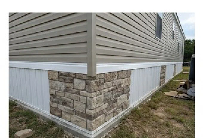 Mobile home skirting with stone accent corner installed in Lavaca County